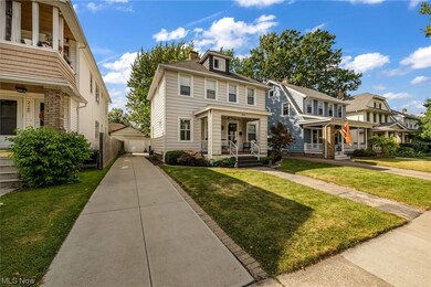 View of front facade with covered porch and a front yard
