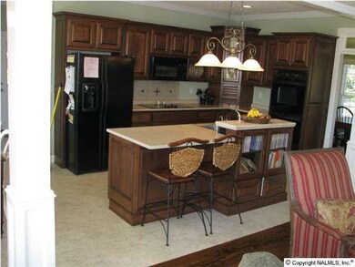 Kitchen features double oven with warming drawer, eating bar, good sized pantry and the refrigerator conveys with the home. Also enjoy built in speakers placed around the home and outside!