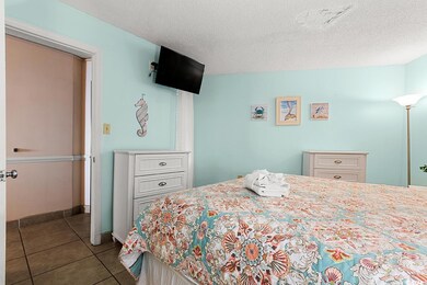 Tiled bedroom with a textured ceiling