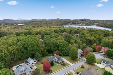 Drone / aerial view of a heavily wooded area and a large body of water