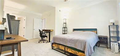 Bedroom with carpet, ornamental molding, and baseboards