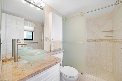 Bathroom with vanity, toilet, and an enclosed show