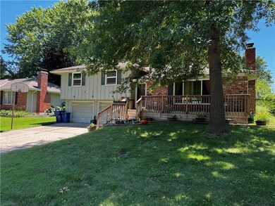 View of front of home with a front yard and a garage