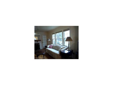 Living room with picture window leads to 3 season 