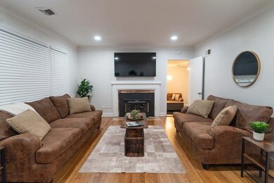 Living room with light hardwood / wood-style floor