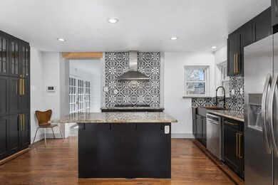 Walled is filled with beautiful  shelving for pantry items.  Note the streamline look and beautiful glass doors on top.