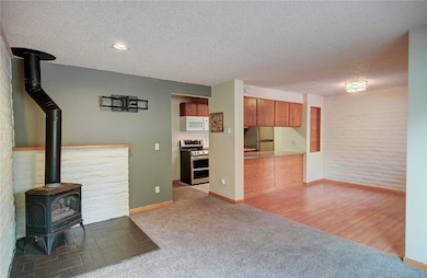 Unfurnished living room with a gas stove, carpet,