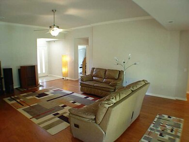 Living Room. hd Wd Floors in LR open to kit/fam rm High ceil/crown mldg and fans