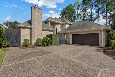 This beautiful home features a spacious two-car garage, a brick exterior, and well-maintained landscaping. The driveway offers ample parking, and the surrounding trees provide a serene, natural backdrop.