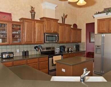 Kitchen has breakfast bar, island and plenty of co