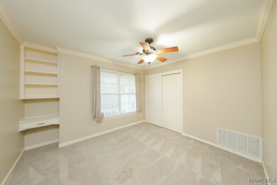Bedroom features built in cabinets.