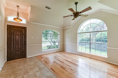 Front Dining Room/Flex space with crown and trim molding, large arched windows.