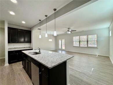 Kitchen featuring baseboards, light wood-style flo