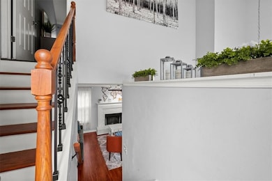 Staircase featuring a fireplace