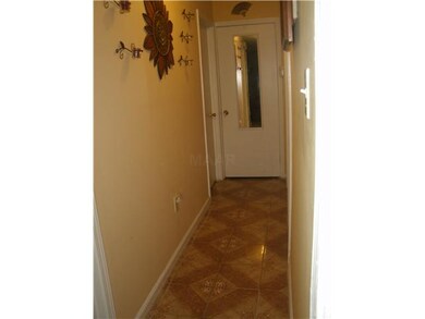 Hallway leads to bedrooms- notice ceramic tile flo