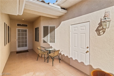 Entrance to property featuring stucco siding and a