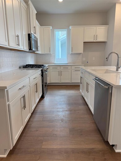 Kitchen featuring dishwashing machine, range, whi