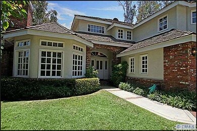 Brick-accented exterior and lush front lawn.