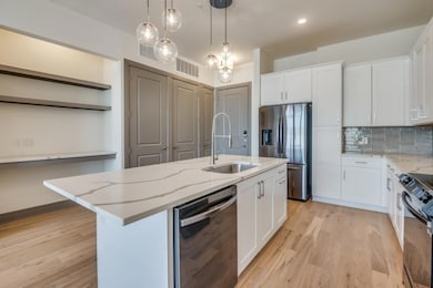 Kitchen featuring a center island with sink, sink,