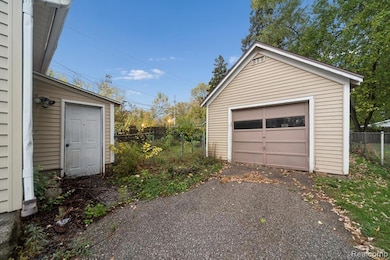 Detached garage with asphalt driveway