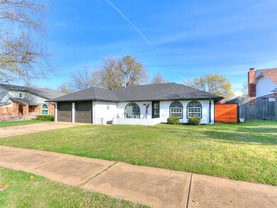 Single story home with a front yard, roof with shi