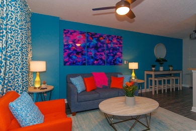 Living room featuring a textured ceiling, wood-typ