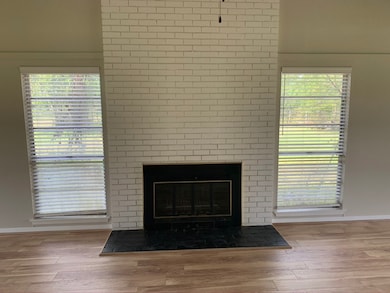 Living room has two medium sized windows that pull