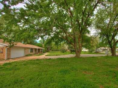 View of yard featuring driveway and an attached ga