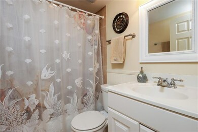 Full bath featuring vanity, a shower with curtain, and wainscoting