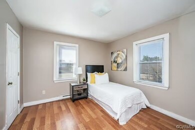 Bedroom featuring baseboards and light wood-style