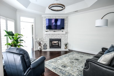 Great room features trey ceiling with modern interior LED lighting.