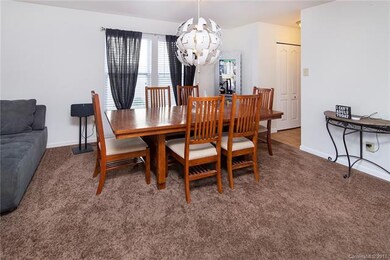 Dining area has entrance to kitchen.