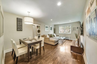 Dining area featuring dark wood-style flooring, st