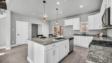 Kitchen featuring stainless steel appliances, a si