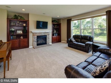 Large living room with built-in bookshelves and ga