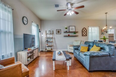 Living room featuring ceiling fan with notable ch