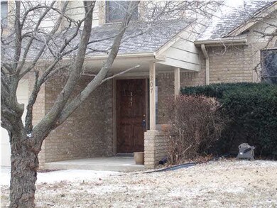 Large covered front porch shelters guests.