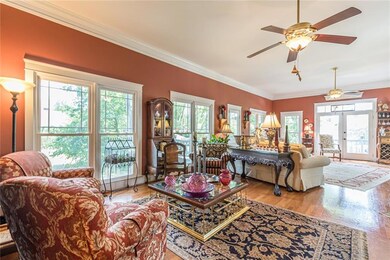 Living area featuring french doors, crown molding,
