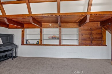 Built in book shelves and antique piano.