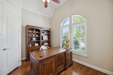 Home office featuring ornamental molding, dark har