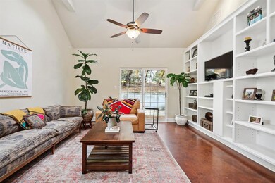 Living room featuring a ceiling fan and vaulted ceiling