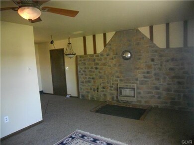 Living room with view of dining room and garage en