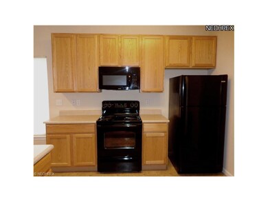 Here is a view of the stove, microwave, and fridge