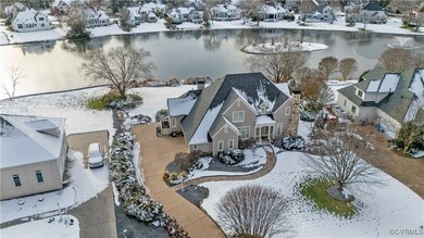 Snowy aerial view with a water view