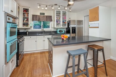 The cook in the family is going to truly appreciate the remodeled kitchen with its sparkling window, modern track lighting, white showcase cabinetry, handy pantry, quartz counter-tops, undermount basin, pull-down faucet, state-of-the-art stainless-st