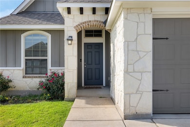View of exterior entry featuring board and batten