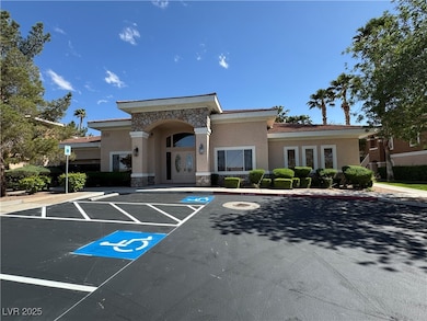 View of building exterior with uncovered parking