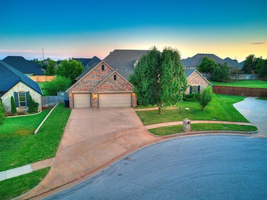 Traditional-style house featuring driveway, a garage, and stone siding