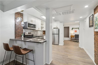 Kitchen with white cabinets, stainless steel appli
