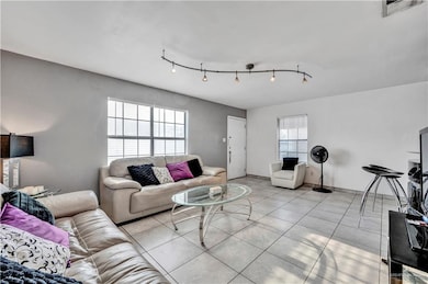 Living area with light tile patterned floors